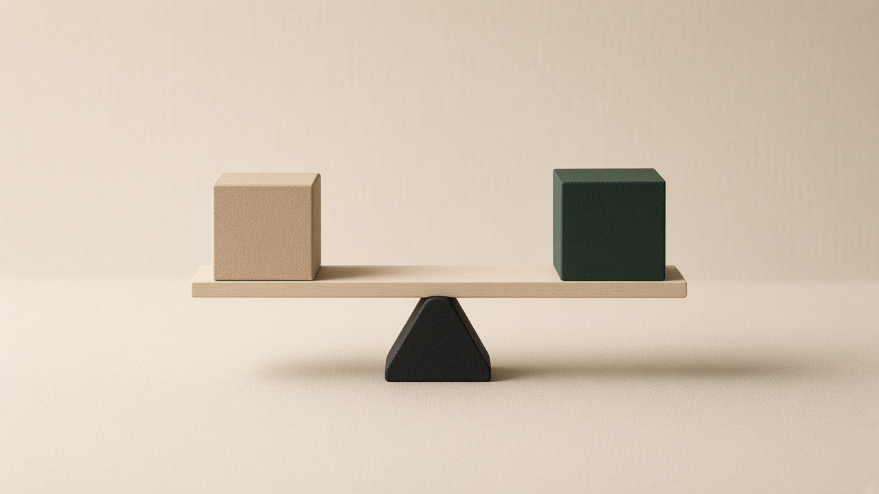 A balance scale with a cream block on one side and a green block on the other.